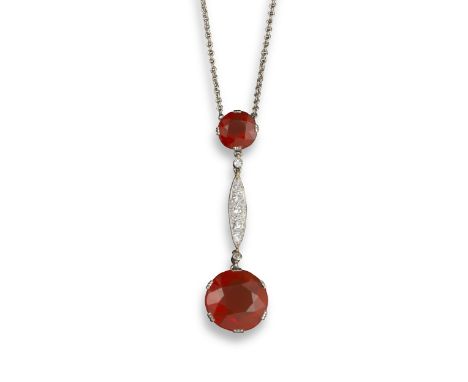An Edwardian fire opal and diamond pendant, the graduated circular fire opals are joined with a lozenge-shaped section milleg