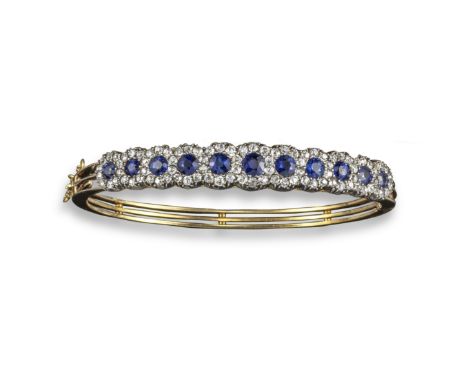 A Victorian sapphire and diamond bangle, set with clusters of circular-cut sapphires within old cushion-shaped diamond surrou