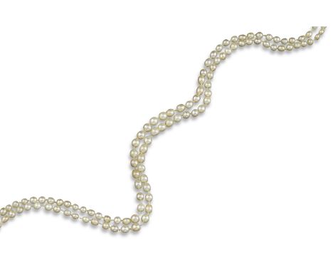 A two-row natural pearl necklace, the pearls graduate fro, 3.8 - 5.4mm approximately, with a pearl, emerald and diamond flowe