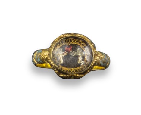 A gold Stuart crystal romantic ring, late 17th century, the faceted crystal covers two winged putti, both clasping a heart wi