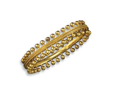 A late 19th century gold bangle by Robert Phillips, the inner band with pellet decoration and set with spherical terminals in