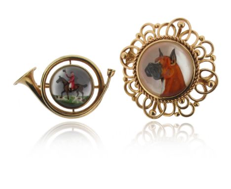 A reverse carved crystal intaglio brooch, depicting a boxer dog, backed on mother of pearl within scrolling gold mount, 3.5cm