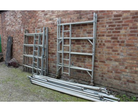 A SCAFFOLDING TOWER IN SECTIONS TO INCLUDE SIDE LADDER SECTIONS, FOOT BOARDS - ON CASTORS