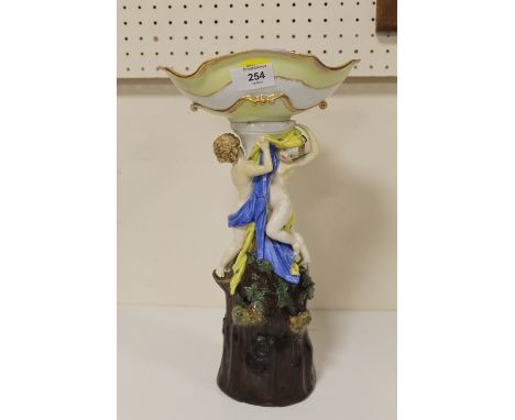 A HAND PAINTED CERAMIC COMPORT DECORATED WITH SEMI NUDE FIGURES - RESTORATION TO BASE HEIGHT - 37CM 