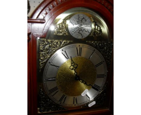 A modern mahogany cased long case clock, the arched brass dial inscribed "Tempus Fugit" over a chapter ring with Roman numera
