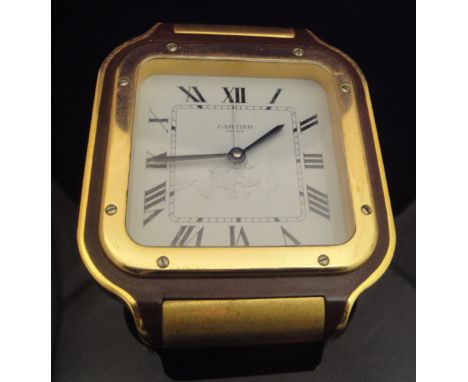 A Cartier of Paris alarm clock, the white enamel dial set with Roman numerals and inscribed "Cartier Paris" to a brass and re