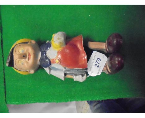 A composition bodied clockwork Pinnochio figure CONDITION REPORTS Nothing is sold as working and although the mechanism does 