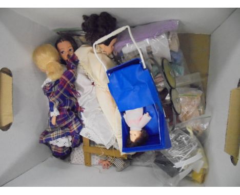 A box containing a Pelham puppet "Andy Pandy", three various Sindy dolls, various clothing, Sindy pram, other accessories and