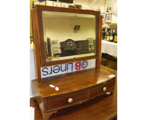 A 19th Century mahogany dressing mirror, the rectangular plate above a bow fronted base of two drawers, raised on bracket fee