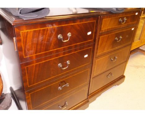 A pair of modern mahogany bedside cabinets, the plain tops above a false door of four drawers, raised on bracket feet, togeth