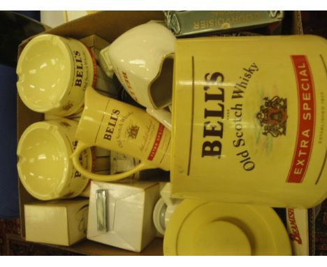 A box containing various pub ephemera including Bell's Scotch Whisky ashtrays and water jugs, ice bucket, Gordon's Gin ashtra