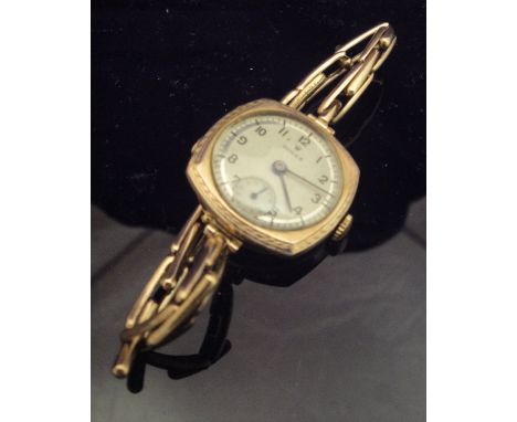 A 9 carat gold cased Rolex wristwatch with expandable bracelet, the brushed dial with Arabic numerals and subsidiary seconds 