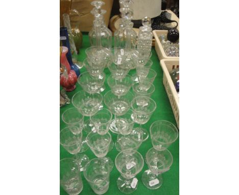 A collection of various cut glassware including two mallet shaped decanters, two onion decanters and stoppers, a hobnail cut 