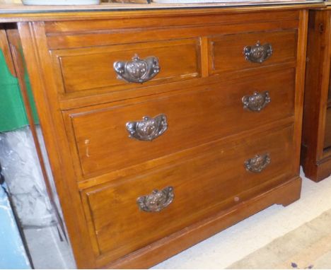 A pair of Edwardian walnut chests of drawers, each with a plain top above two short drawers and two long drawers, raised on b