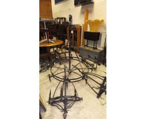 A large wrought iron eight light electrolier in the Victorian Gothic taste, together with a four matching three light wall li