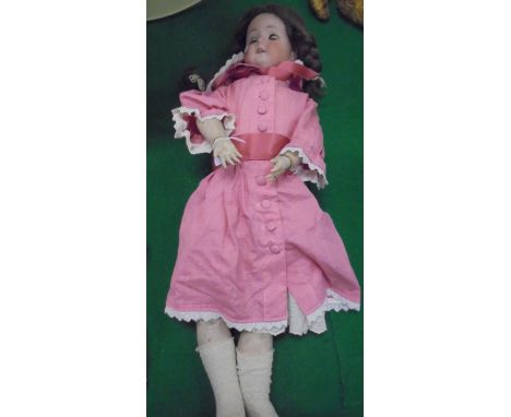 A Goebel porcelain headed doll with composition jointed body, the head marked with Goebel mark and "L - Bavaria", sleep eyes 