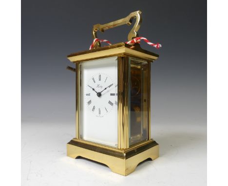 An English gilt brass Carriage Clock, of typical five-glass form. signed 'Henley' and 'Made in England', the movement also si