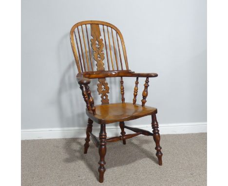 A 20thC Georgian style ash and elm Windsor Armchair, comb back&nbsp;with shaped and pierced splats, scrolled arms and turned 