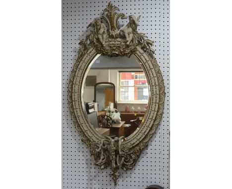 A giltwood and gesso oval girondelle wall Mirror, with candle holders, H 113 cm x W 60 cm. 