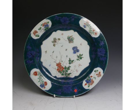 An antique Chinese porcelain Plate, with decorative floral enamels, enclosed within powder blue ground overlayed with green c