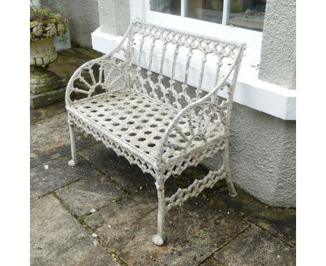 A Georgian style painted metal garden Seat, the back and arm panels with Gothic style open work tracery above a pierced honey