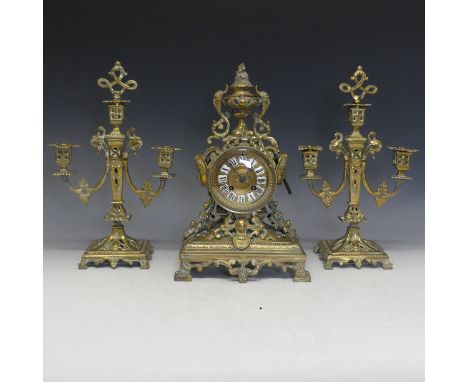 A 19th Century French gilt brass Clock Garniture, including a pair of three-light candelabra, the 8-day movement striking on 