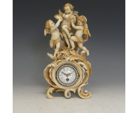 An early-20th century German ceramic-mounted mantle Clock, putti and angles, white enamel dial with Arabic chapter and finely