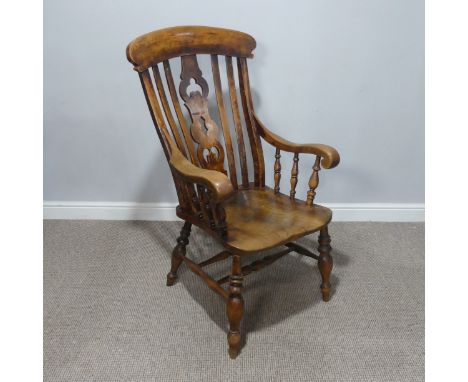 An Antique ash and elm Windsor Chair, stick and pierced carved splat back, above moulded saddle seat, raised on turned legs u