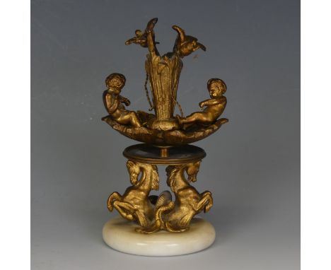 An Antique gilt metal candlestick Holder, depicting two boys with chained birds, raised on horses, W 9 cm x H 16 cm x D 8 cm.