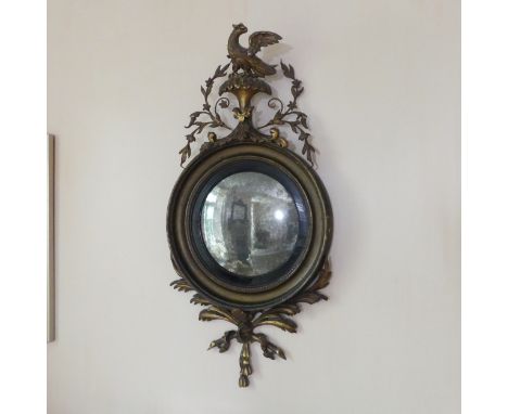 A Regency giltwood and gesso circular convex Mirror, with eagle finial and foliate drop, H 96 cm x W 47 cm. 