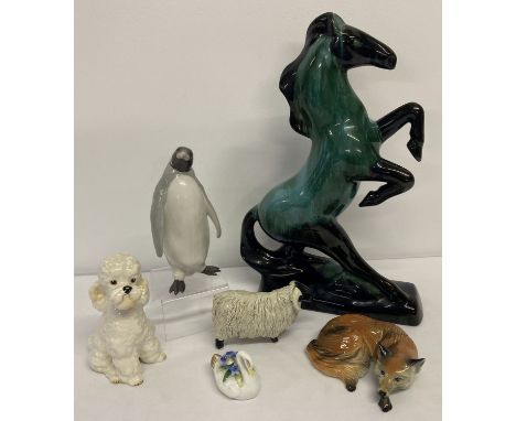 A collection of ceramic animal figurines.  To include: a large Canadian Blue Mountain pottery rearing horse, Sylvac poodle, M