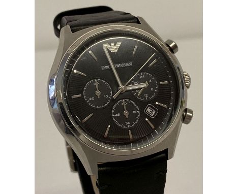 A men's chronograph wristwatch by Emporio Armani. Silver tone case with black engine turned face.  Seconds hand and date func