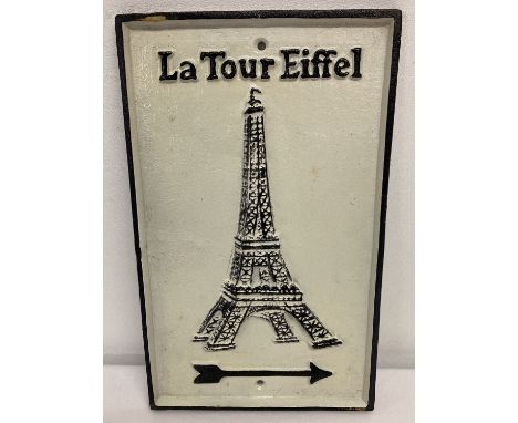 A black and white painted cast iron wall sign with directional arrow for the Eiffel Towel.   Approx. 31cm x 19cm.