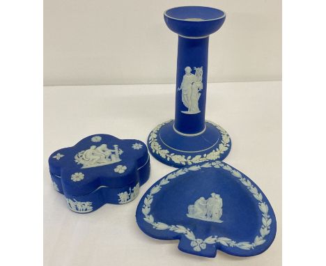 3 pieces of dark blue jasperware ceramics by Wedgwood.  A candlestick, a lidded trinket box and a small pin tray. 