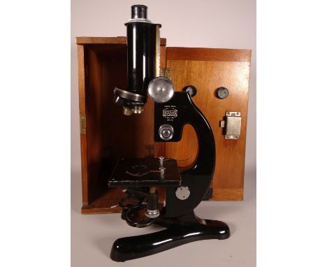 A vintage black painted Microscope by Beck, London. Model 47.  Complete with fitted wooden case with leather carry handle.  A