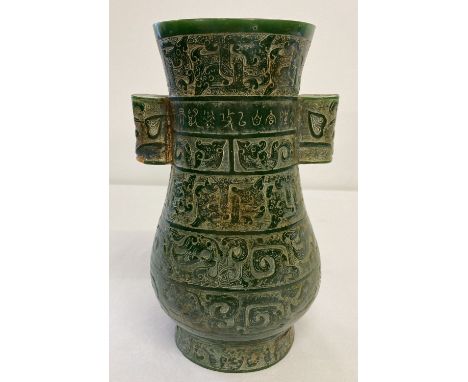 A highly carved Chinese jade vase of Archaic form with carving throughout.   Approx. 25cm tall.