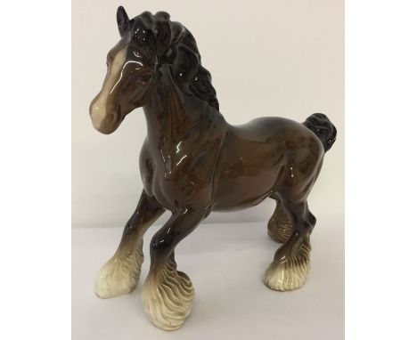 A Beswick ceramic Cantering Shire horse, in brown gloss finish.  Model #975, discontinued in 1989, designed by Arthur Greding