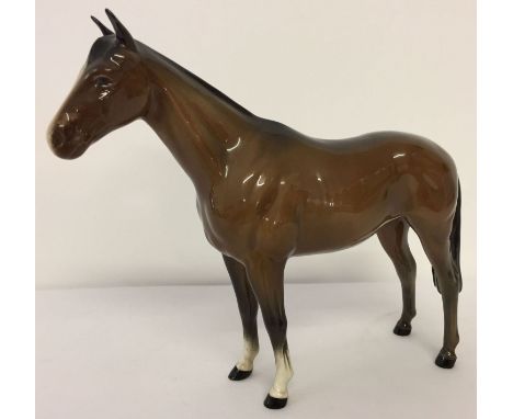 Beswick ceramic horse figurine "Imperial", in brown gloss colourway. Model #1557.  Designed by Albert Hallam &amp; James Hayw