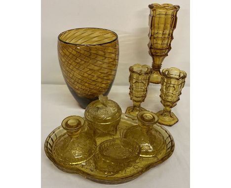 A collection of vintage amber coloured glass.  To include dressing table vanity set with butterfly detail. And a trio of matc