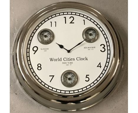 A large modern wall hanging, multi dial, world cities, clock with chrome finish.  Showing dials for the time in London, Melbo