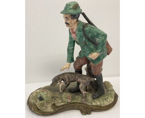 A large Capodimonte ceramic figure of a hunter and his dog a/f.   Approx. 30 long x 31cm tall.