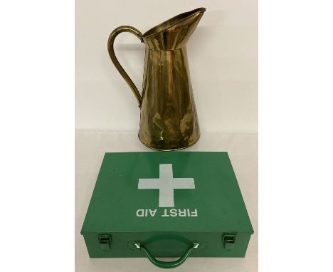 A large vintage brass jug together with a green metal first aid box with carry handle.   Jug approx. 43cm tall.