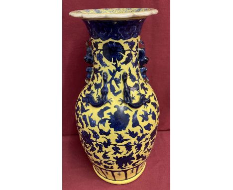 A 19th century blue and yellow Chinese vase with Chilong and Shishi decoration.  Crack to top rim running down the neck of va