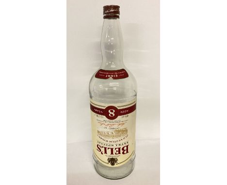 A large empty Bell's Old Scotch Whiskey bottle.   Approx. 50 cm tall.