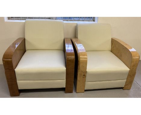 2 Art Deco style armchairs with veneered wooden arms and cream faux leather upholstery.  One chair with walnut veneer finish,