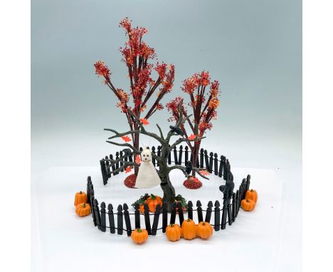 A ghostly Village accessory including 2 Autumn trees, 12 Halloween fences, 1 Halloween spooky tree, and 1 ghost. Department 5