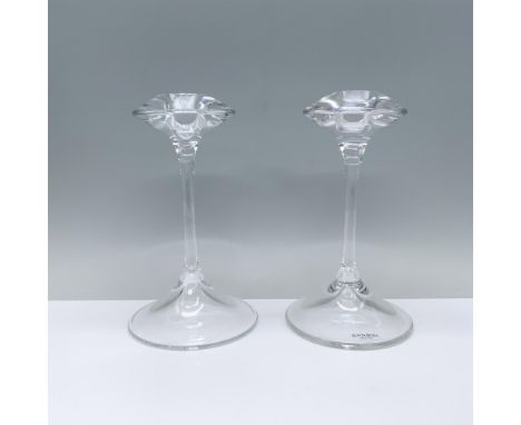 An elegant pair of clear candlesticks featuring a rounded base, a slender stem, and a cymbal-shaped top with a candle holder.