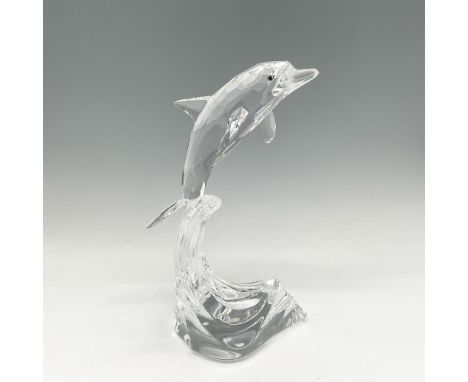 Clear crystal figural riding a wave looking ahead with his aqua amber crystal eyes. Swarovski backstamp. 7644 000 004. This i