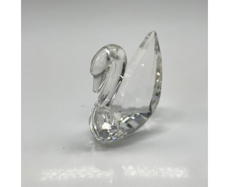 Clear crystal logo figural with smooth neck and faceted body. Swarovski backstamp. This item has its original box: 9.5"L x 4"