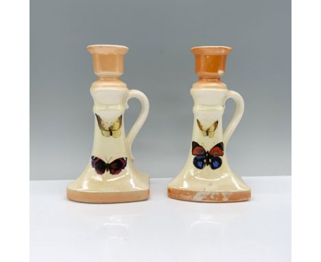 Yellow and orange candlesticks with butterfly artwork at the center, featuring handles for easy transportation. Marked Czecho